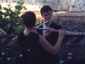 Olivia & David Buck playing their flutes in the middle of the Tiber River